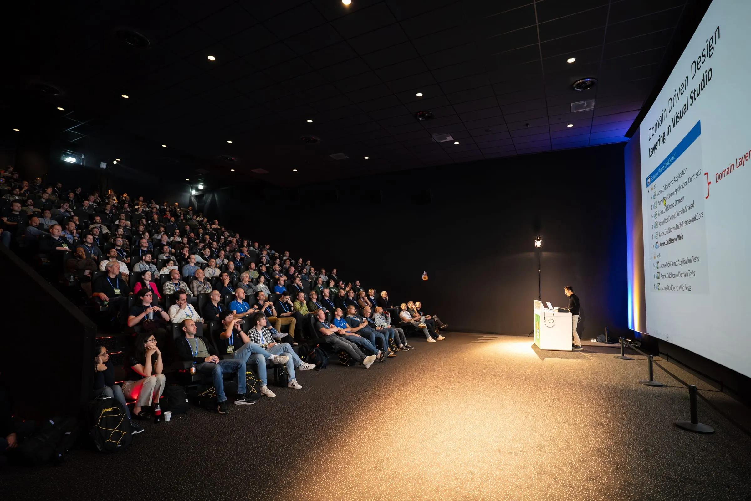 A full auditorium at Techorama Netherlands 2025, with Halil İbrahim Kalkan presenting a Domain-Driven Design session